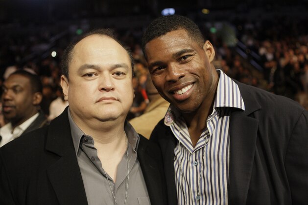 Strikeforce promoter Scott Coker, left, poses for a photo with former NFL football player Herschel Walker before watching a WBA Super Middleweight championship boxing fight in Oakland, Calif., Saturday, Nov. 21, 2009. (AP Photo/Jeff Chiu)