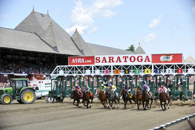 Horses break from the starting gate during the first race on opening day of the horse racing season at Saratoga Race Course in Saratoga Springs, N.Y., Friday, July 18, 2014. (AP Photo/Hans Pennink)