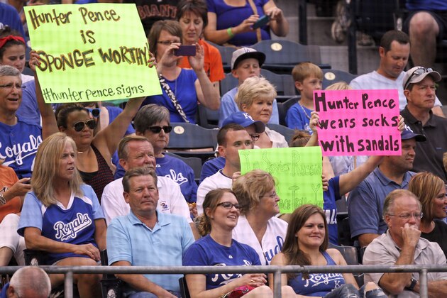 Fans hold up signs as San Francisco Giants' Hunter Pence bats in the first inning during a baseball game against the Kansas City Royals, Friday, Aug. 8, 2014, in Kansas City, Mo. (AP Photo/Ed Zurga)