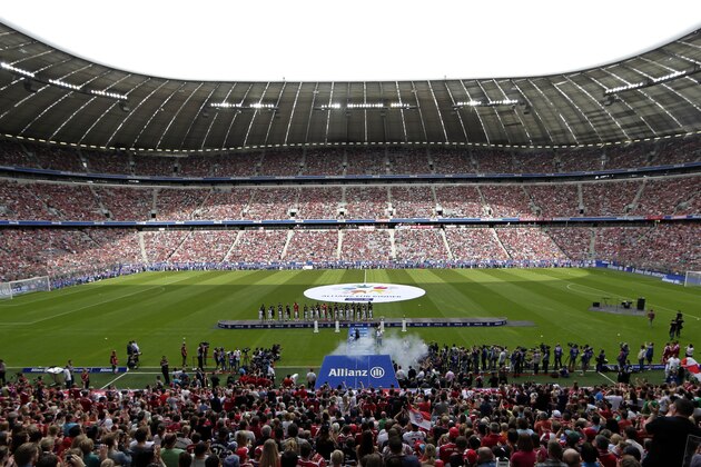 FC Bayern Munich players pose during an official team presentation in the Allianz Arena stadium for the new German soccer first division Bundesliga season, in Munich, southern Germany, Saturday, Aug. 9, 2014. 65,000 spectators attended the event. (AP Photo/Matthias Schrader)