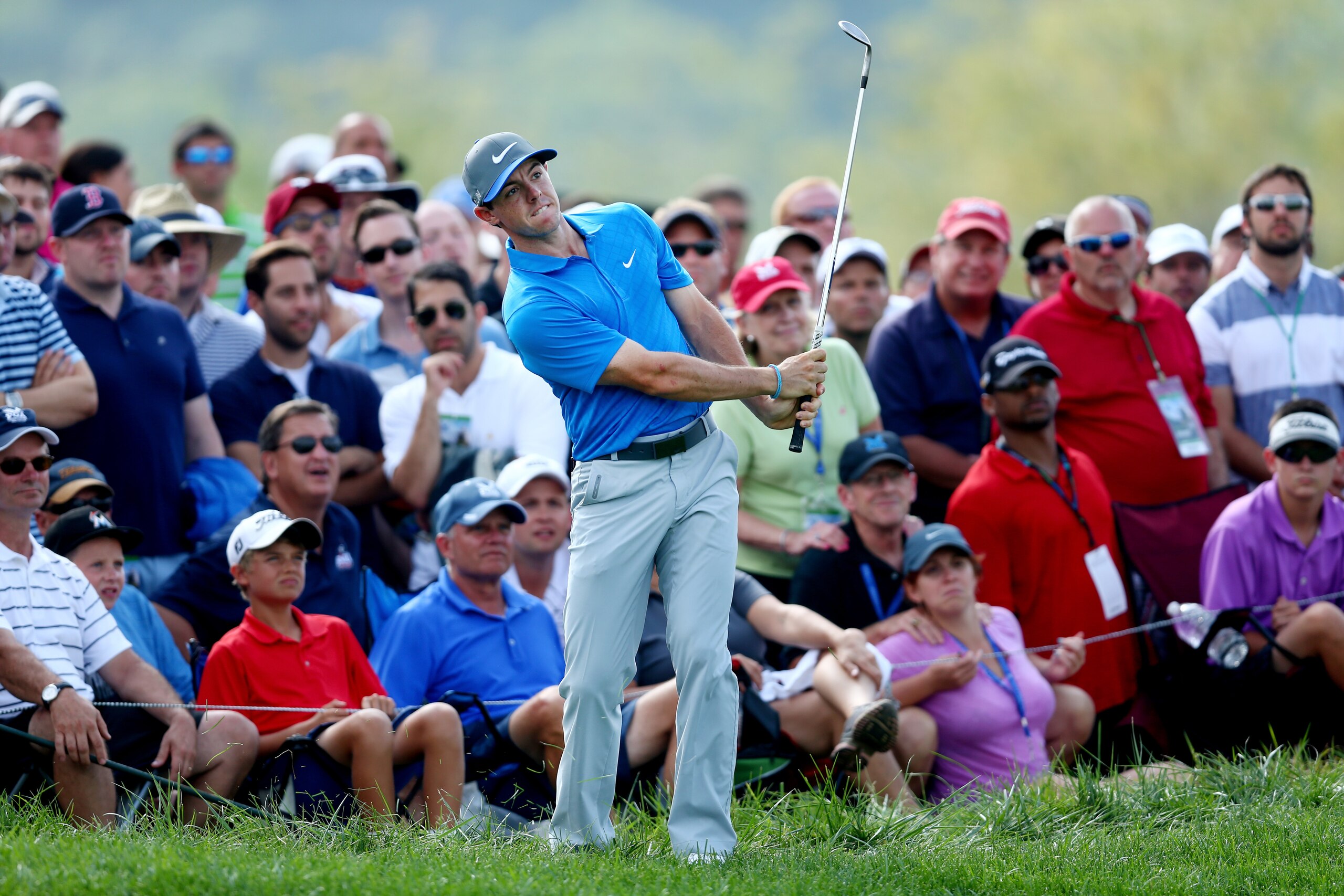 LOUISVILLE, KY - AUGUST 09:  Rory McIlroy of Northern Ireland chips to the tenth green as a gallery of patrons look on during the third round of the 96th PGA Championship at Valhalla Golf Club on August 9, 2014 in Louisville, Kentucky.  (Photo by Jeff Gross/Getty Images)