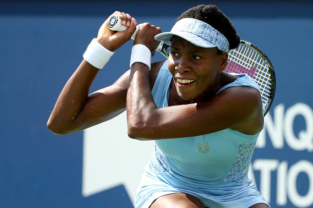 MONTREAL, QC - AUGUST 09:  Venus Williams of the USA returns a shot to Serena Williams of the USA during the women's semifinals match in the Rogers Cup at Uniprix Stadium on August 9, 2014 in Montreal, Canada.  (Photo by Streeter Lecka/Getty Images)
