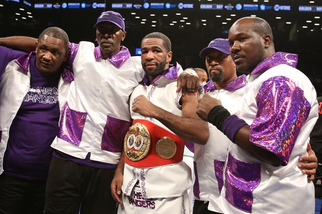 BROOKLYN, NY - AUGUST 9: Lamont Peterson (White w/Purple trunks) poses after his TKO win over Edgar Santana (not shown) in their IBF junior welterweight championship fight at the Barclays Center on August 9, 2014 in Brooklyn, New York. (Photo by Ed Mulholland/Getty Images)