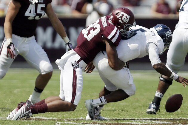 Rice's Driphus Jackson (5) fumbles the ball as he is hit by Texas A&M defender Shaan Washington (33) during the fourth quarter of an NCAA college football game, Saturday,  Aug. 31, 2013, in College Station, Texas. Texas A&M won 52-31.    (AP Photo/Eric Gay)