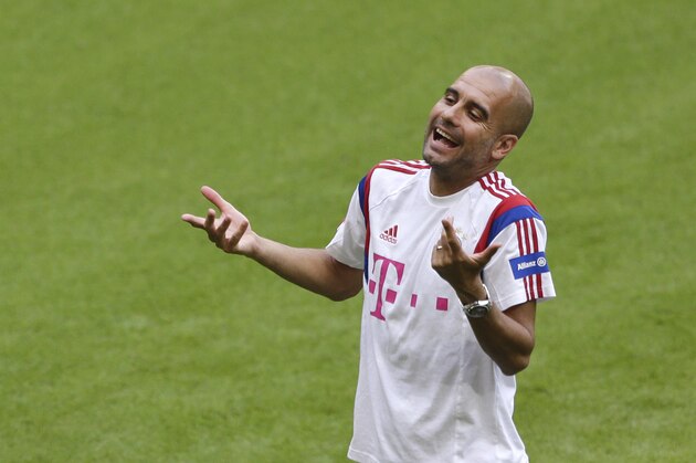 Bayern Munich head coach Pep Guardiola of Spain gestures during a training session after an official team presentation in the Allianz Arena stadium for the new German first division Bundesliga soccer season, in Munich, southern Germany, Saturday, Aug. 9, 2014. 65,000 spectators attended the event. (AP Photo/Matthias Schrader)
