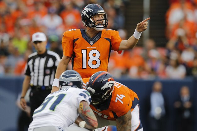 Denver Broncos quarterback Peyton Manning (18) calls a play against the Seattle Seahawks during the first half of an NFL preseason football game, Thursday, Aug. 7, 2014, in Denver. (AP Photo/Jack Dempsey)
