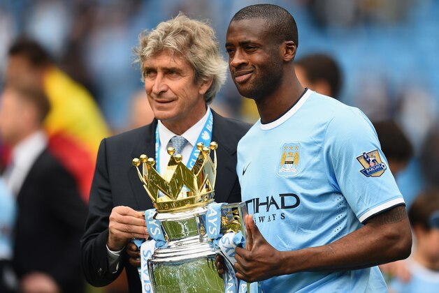 MANCHESTER, ENGLAND - MAY 11:  The Manchester City Manager Manuel Pellegrini and Yaya Toure pose with the trophy at the end of the Barclays Premier League match between Manchester City and West Ham United at the Etihad Stadium on May 11, 2014 in Manchester, England.  (Photo by Shaun Botterill/Getty Images)