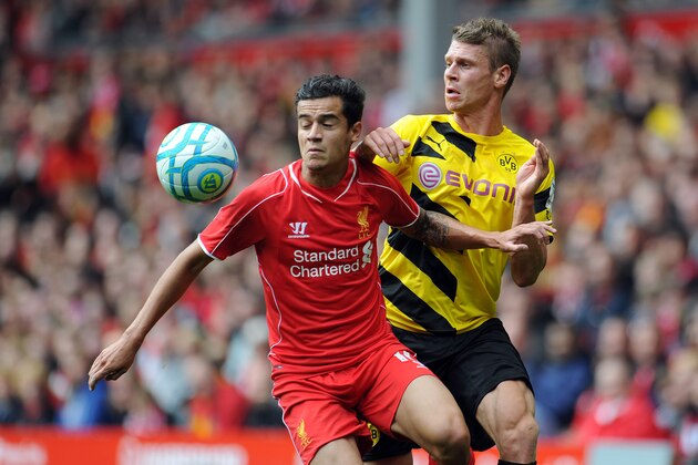 LIVERPOOL, ENGLAND - AUGUST 10:  Philippe Coutinho of Liverpool and Lukasz Piszczek of Borussia Dortmund battle for the ball during the Pre Season Friendly match between Liverpool and Borussia Dortmund at Anfield on August 10, 2014 in Liverpool, England. (Photo by Clint Hughes/Getty Images)