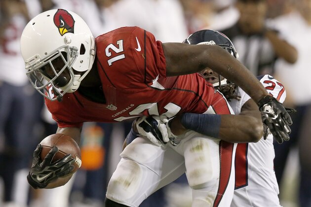 Arizona Cardinals' John Brown (12) gets tackled by Houston Texans' Josh Victorian (27) after Brown made a catch during the first half of an NFL football game Saturday, Aug. 9, 2014, in Glendale, Ariz. (AP Photo/Ross D. Franklin)