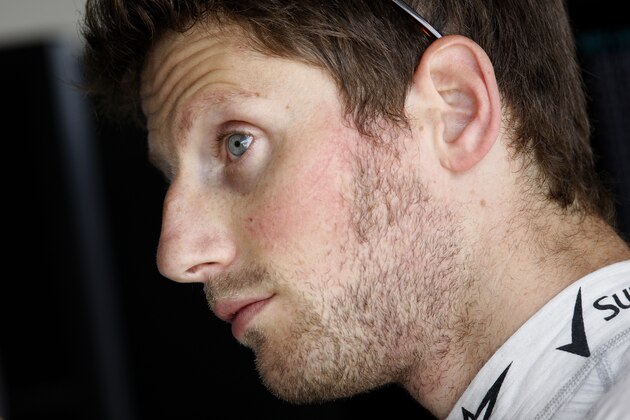NORTHAMPTON, ENGLAND - JULY 04:  Romain Grosjean of France and Lotus looks on in the garage after practice ahead of the British Formula One Grand Prix at Silverstone Circuit on July 4, 2014 in Northampton, United Kingdom.  (Photo by Drew Gibson/Getty Images)