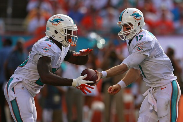 MIAMI GARDENS, FL - SEPTEMBER 22: Ryan Tannehill #17 of the Miami Dolphins hands off to Lamar Miller #26 during a game against the Atlanta Falcons at Sun Life Stadium on September 22, 2013 in Miami Gardens, Florida.  (Photo by Mike Ehrmann/Getty Images)
