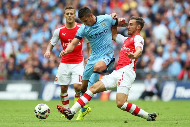 LONDON, ENGLAND - AUGUST 10:  Stevan Jovetic of Manchester City is challenged by Jack Wilshere (L) and Aaron Ramsey of Arsenal during the FA Community Shield match between Manchester City and Arsenal at Wembley Stadium on August 10, 2014 in London, England.  (Photo by David Rogers/Getty Images)