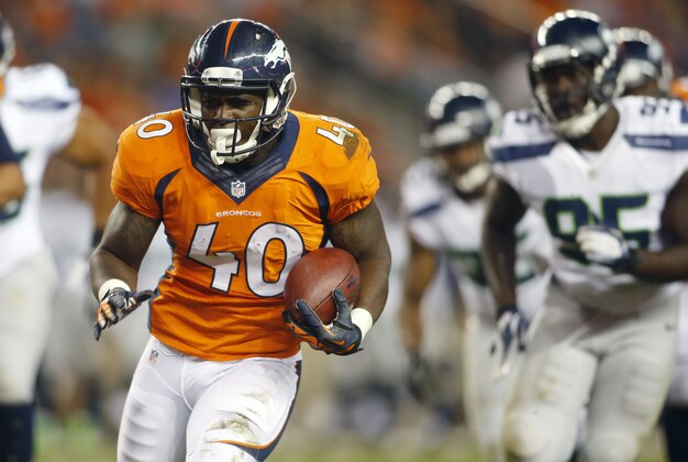 Aug 7, 2014; Denver, CO, USA; Denver Broncos running back Juwan Thompson (40) runs the ball during the second half against the Seattle Seahawks at Sports Authority Field at Mile High. The Broncos won 21-16. Mandatory Credit: Chris Humphreys-USA TODAY Sports