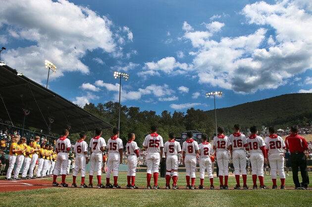 WILLIAMSPORT, PA - AUGUST 25: Members of the West team from Chula Vista, Ca and the Tokyo, Japan team line up before the start of the Little League World Series Championship game on August 25, 2013 in Williamsport, Pennsylvania.  (Photo by Rob Carr/Getty Images)