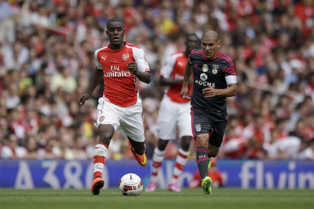 Making his debut Arsenal's Joel Campbell competes for the ball with Benfica's Maxi Pereira, right, during the Emirates Cup soccer match between between Arsenal and Benfica at Arsenal's Emirates Stadium in London, Saturday, Aug. 2, 2014.  (AP Photo/Matt Dunham)