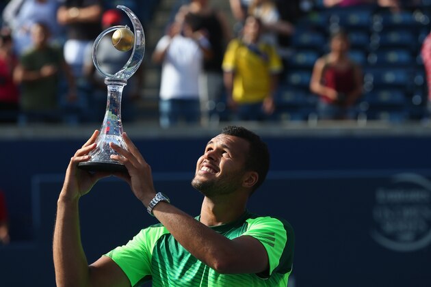 TORONTO, ON - AUGUST 10:  Jo-Wilfried Tsonga of France holds up the Rogers Cup trophy after his win against Roger Federer of Switzerland during Rogers Cup at Rexall Centre at York University on August 10, 2014 in Toronto, Canada.  (Photo by Ronald Martinez/Getty Images)