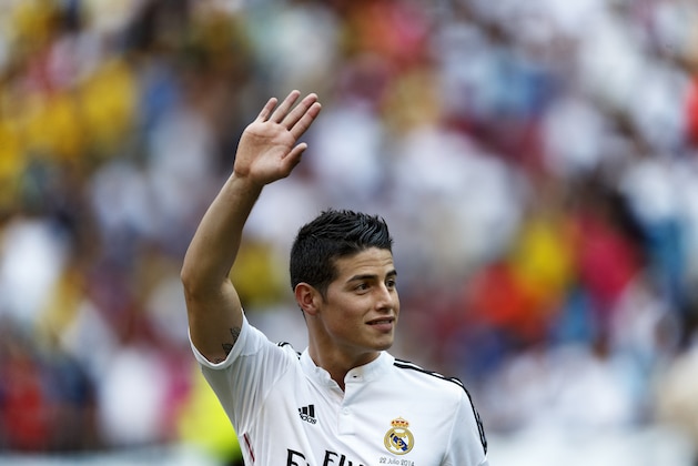 FILE - In this July 22, 2014 file photo, new Real Madrid player James Rodriguez, from Colombia, waves during his official presentation at the Santiago Bernabeu stadium in Madrid, Spain. Real Madrid have signed Rodriguez from Monaco on a six-year contract,  (AP Photo/Daniel Ochoa de Olza, File)