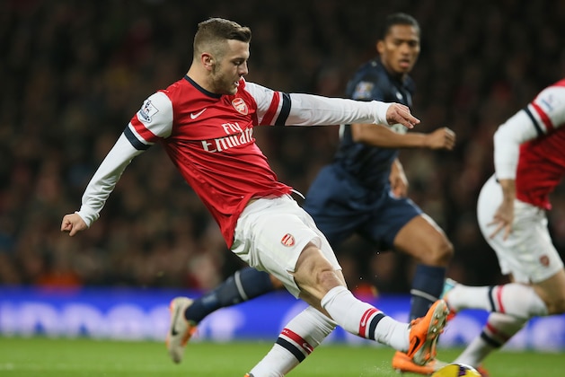 Arsenal's Jack Wilshere takes a shot at goal during their English Premier League soccer match between Arsenal and Manchester United at the Emirates stadium in London, Wednesday, Feb. 12, 2014. (AP Photo/Alastair Grant)