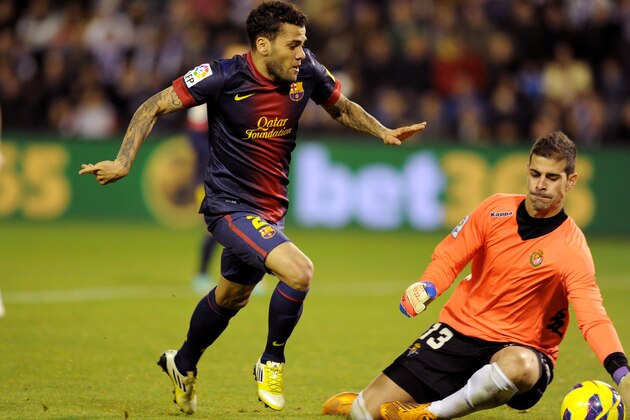 FC Barcelona's Dani Alves from Brazil, left, duels for the ball next to Real Valladolid's goalkeeper Jaime Jiménez, right, during a Spanish La Liga soccer match at the Jose Zorrilla stadium in Valladolid, Spain on Saturday, Dec 22, 2012. (AP Photo/Israel l.Murillo) FC Barcelona's Dani Alves from Brazil, left, duels for the ball next to Real Valladolid's goalkeeper Jaime Jiménez, right, during a Spanish La Liga soccer match at the Jose Zorrilla stadium in Valladolid, Spain on Saturday, Dec 22, 2012. (AP Photo/Israel l.Murillo)