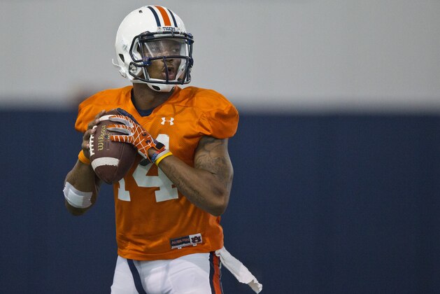 Auburn quarterback Nick Marshall (14) drops back to throw the ball during an NCAA college football practice on Tuesday, Aug. 5, 2014, in Auburn, Ala.(AP Photo/Brynn Anderson)
