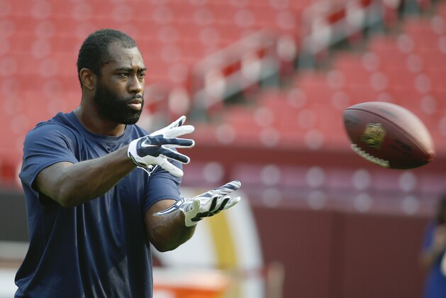New England Patriots cornerback Darrelle Revis warms up before an NFL football preseason game against Washington Redskins in Landover, Md., Thursday, Aug. 7, 2014. (AP Photo/Alex Brandon)