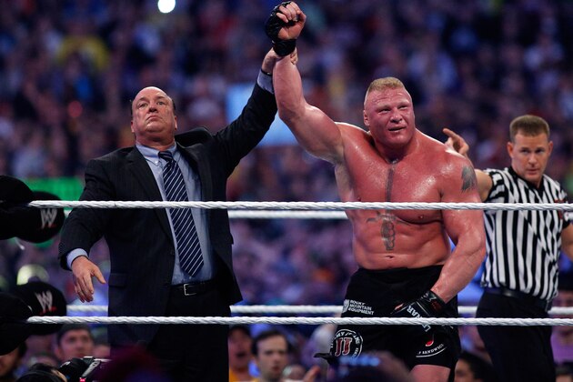 Paul Heyman, left, celebrates with Brock Lesnar after his win over the Undertaker  during Wrestlemania XXX at the Mercedes-Benz Super Dome in New Orleans on Sunday, April 6, 2014. (Jonathan Bachman/AP Images for WWE)