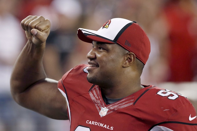 Arizona Cardinals' Calais Campbell smiles as he pumps his fist to cheering fans during the first half of an NFL preseason football game against the Houston Texans Saturday, Aug. 9, 2014, in Glendale, Ariz.  The Cardinals defeated the Texans 32-0. (AP Photo/Ross D. Franklin)