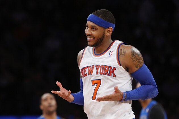 FILE - In this Feb. 24, 2014, file photo, New York Knicks' Carmelo Anthony (7) smiles after hitting a 3-point shot against the Dallas Mavericks during an NBA basketball gam in New York. Anthony is remaining with the Knicks, saying he wants
