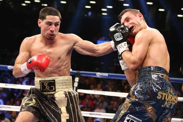 BROOKLYN, NY - AUGUST 9: Danny Garcia (Brown/Gold trunks) lands a left hook to the head of Rod Salka (Black/Gold trunks) during their fight at the Barclays Center on August 9, 2014 in Brooklyn, New York. (Photo by Ed Mulholland/Getty Images)