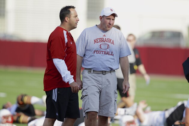 Nebraska head coach Bo Pelini, right, and defensive coordinator John Papuchis follow Nebraska's first day of NCAA college football practice in Lincoln, Neb., Monday, Aug. 4, 2014. (AP Photo/Nati Harnik)