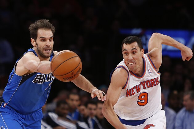 Dallas Mavericks' Jose Calderon, left, of Spain, scrambles for a loose ball with New York Knicks' Pablo Prigioni (9), of Argentina, during the first half of an NBA basketball game Monday, Feb. 24, 2014, in New York.  Dallas won 110-108. (AP Photo/Jason DeCrow)