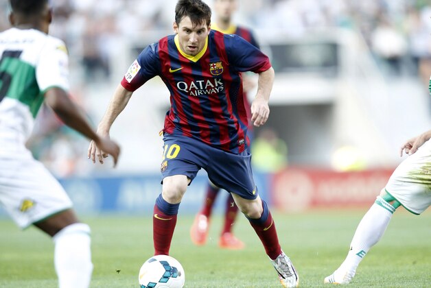 Barcelona's Lionel Messi from Argentina,  controls the ball past Elche's  Alberto Rivera Pizarro, left, during a Spanish La Liga soccer match at the Martinez Valero stadium in Elche, Spain, on Sunday, May 11, 2014. (AP Photo/Alberto Saiz)