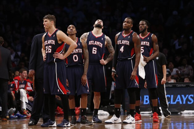 Atlanta Hawks players Kyle Korver (26), Jeff Teague (0), Pero Antic (6), of Macedonia, Paul Millsap (4) and DeMarre Carroll (5) react during the second half of an NBA basketball game against the Brooklyn Nets Friday, April 11, 2014, in New York.  Atlanta won 93-88. (AP Photo/Jason DeCrow)