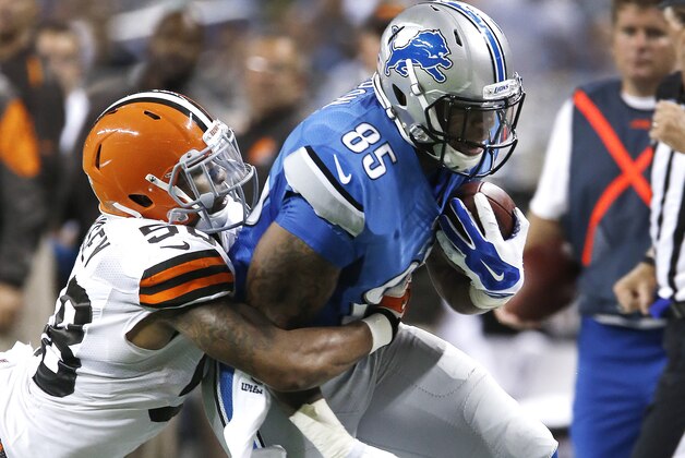 Detroit Lions tight end Eric Ebron (85) is brought down by Cleveland Browns outside linebacker Christian Kirksey (58) in the first half of a preseason NFL football game at Ford Field in Detroit, Saturday, Aug. 9, 2014.  (AP Photo/Duane Burleson)