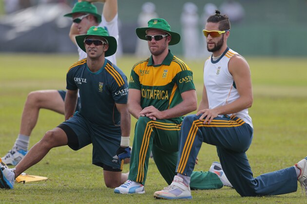 South African ODI cricket team captain AB de Villiers, center, along with teammates Jean Paul- Dumini, left, and Wayne Parnell stretch during a training session before their warm up game against Sri Lanka Board XI in Moratuwa on the outskirts of Colombo, Sri Lanka, Thursday, July 3, 2014. (AP Photo/Eranga Jayawardena)
