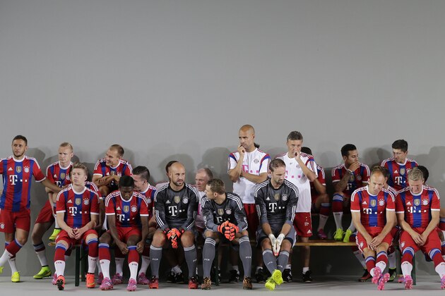 Bayern Munich players wait for the start of an official photo shooting for the new German first division Bundesliga season in Munich, southern Germany, Saturday, Aug. 9, 2014. (AP Photo/Matthias Schrader)