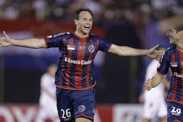 Mauro Matos of Argentina's San Lorenzo, left celebrates with temamate Ignacio Piatti after scoring against Paraguay's Nacional, during a Copa Libertadores final soccer match in Asuncion, Paraguay, Wednesday, Aug. 6, 2014. (AP Photo/Jorge Saenz)