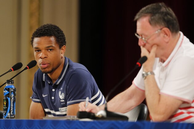 France's player Loic Remy speaks during a press conference as his team's Press Manager Philippe Tournon sits next to him in Ribeirao Preto, Brazil, Friday, June 13, 2014. France is in group E at the World Cup soccer tournament and plays its first match Sunday. (AP Photo/David Vincent)