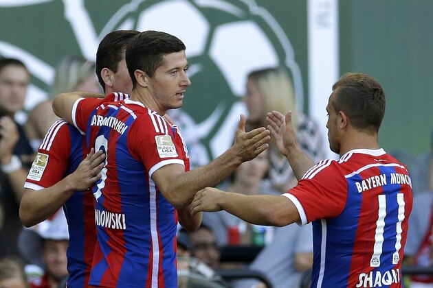 Bayern Munich's Robert Lewandowski, (9) is greeted by Xherdan Shaqiri, right, after Lewandowski scored a goal against the MLS All-Stars in the first half of the MLS soccer All-Star match, Wednesday, Aug. 6, 2014, in Portland, Ore. (AP Photo/Ted S. Warren)