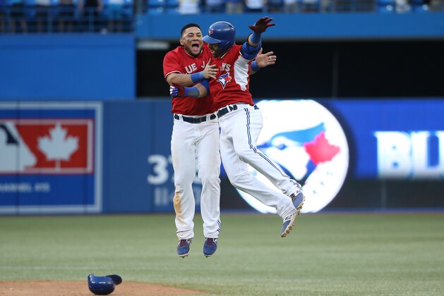 TORONTO, CANADA - AUGUST 10: Jose Bautista #19 of the Toronto Blue Jays is congratulated on his game-winning hit by Melky Cabrera #53 in the ninteenth inning during MLB game action against the Detroit Tigers on August 10, 2014 at Rogers Centre in Toronto, Ontario, Canada. (Photo by Tom Szczerbowski/Getty Images) TORONTO, CANADA - AUGUST 10: Jose Bautista #19 of the Toronto Blue Jays is congratulated on his game-winning hit by Melky Cabrera #53 in the ninteenth inning during MLB game action against the Detroit Tigers on August 10, 2014 at Rogers Centre in Toronto, Ontario, Canada. (Photo by Tom Szczerbowski/Getty Images)