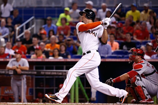 MIAMI, FL - AUGUST 11:  Giancarlo Stanton #27 of the Miami Marlins hits a home run during the first inning of the game against the St. Louis Cardinals at Marlins Park on August 11, 2014 in Miami, Florida.  (Photo by Rob Foldy/Getty Images)