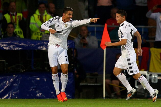 CARDIFF, WALES - AUGUST 12:  (L-R) Cristiano Ronaldo of Real Madrid celebrates with teammate James Rodriguez after scoring their team's second goal during the UEFA Super Cup between Real Madrid and Sevilla FC at Cardiff City Stadium on August 12, 2014 in Cardiff, Wales.  (Photo by Clive Mason/Getty Images)