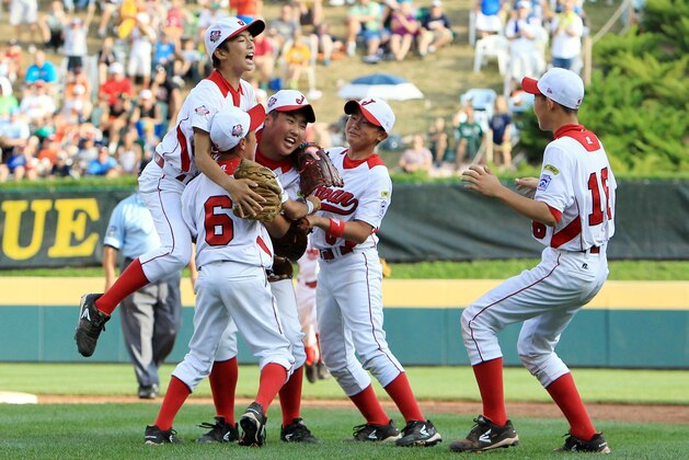 Aug 25, 2013; Williamsport, PA, USA; Japan players celebrate after defeating California (West) 6-4 in the Little League World Series championship game at Lamade Stadium. Mandatory Credit: Matthew O'Haren-USA TODAY Sports