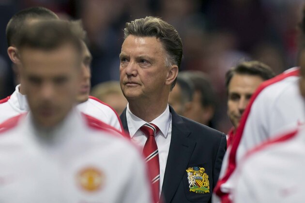 Manchester United's new manager Louis van Gaal, centre,  takes to the touchline before his team's pre season friendly soccer match against Valencia at Old Trafford Stadium, Manchester, England, Tuesday Aug. 12, 2014. (AP Photo/Jon Super)