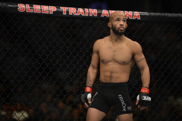 December 14, 2013; Sacramento, CA, USA; Demetrious Johnson (red gloves) fights Joseph Benavidez (blue gloves) during the flyweight championship bout of the UFC on FOX 9 at Sleep Train Arena. Johnson defeated Benavidez. Mandatory Credit: Kyle Terada-USA TODAY Sports