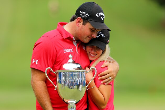 GREENSBORO, NC - AUGUST 18:  (L-R) Patrick Reed and his wife Justine celebrate after defeating Jordan Spieth on the second hole of a playoff during the final round of the Wyndham Championship at Sedgefield Country Club on August 18, 2013 in Greensboro, North Carolina.  (Photo by Tyler Lecka/Getty Images)