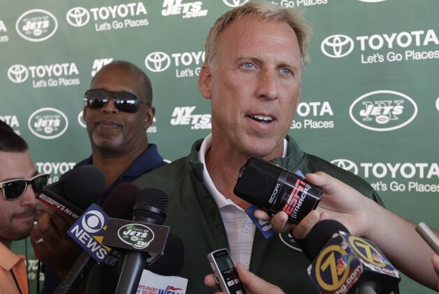 Jets general manager John Idzik responds to questions during a news interview after practice during NFL football training camp Friday, July 25, 2014, in Cortland, N.Y.  (AP Photo)