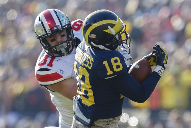 Nov 30, 2013; Ann Arbor, MI, USA; Michigan Wolverines defensive back Blake Countess (18) intercepts the pass intended for Ohio State Buckeyes tight end Nick Vannett (81) in the second quarter at Michigan Stadium. Mandatory Credit: Rick Osentoski-USA TODAY Sports