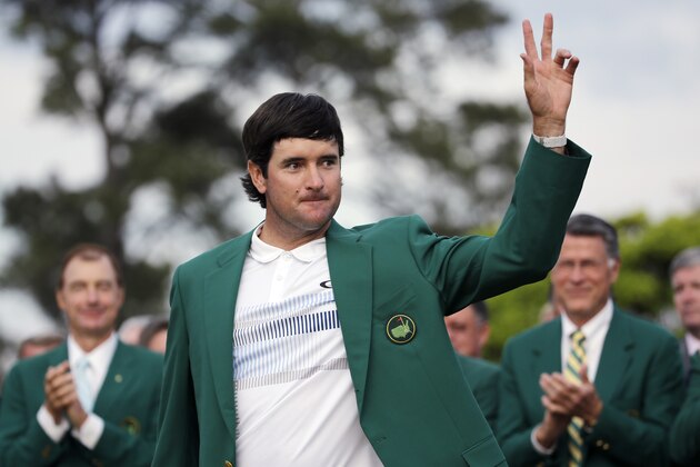 Bubba Watson waves after being presented with his green jacket after winning the Masters golf tournament Sunday, April 13, 2014, in Augusta, Ga.  (AP Photo/David J. Phillip)