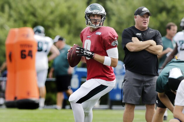 Philadelphia Eagles quarterback Nick Foles fades back to throw as head coach Chip Kelly, right, stands near during an NFL Football training camp scrimmage of the New England Patriots and Eagles in Foxborough, Mass., Tuesday, Aug. 12, 2014. (AP Photo/Charles Krupa)